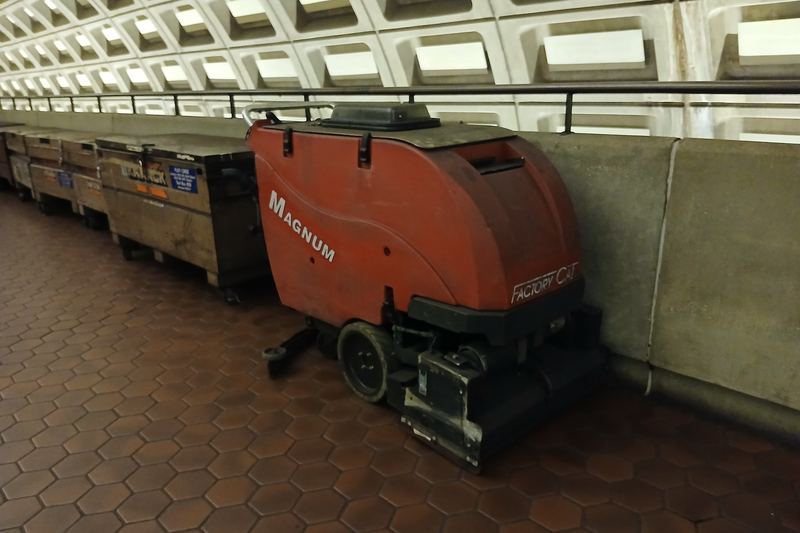 Industrial floor scrubber in a large indoor space